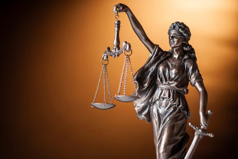 Bronze Statue Of Justice Holding Up Scales