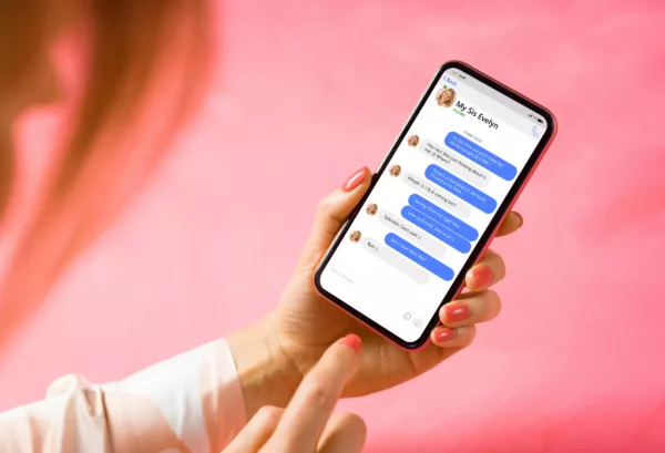 Woman Using Messaging App On Mobile Phone. Mockup Of Sample Chat
